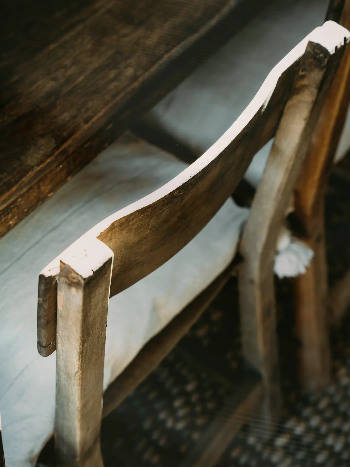 Detail of a weathered wooden chair in the sala